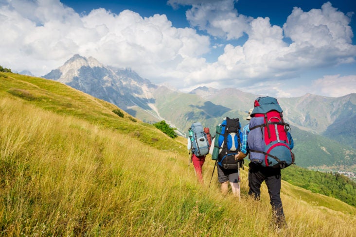 Team of hikers with backpacks Team of hikers with backpacks