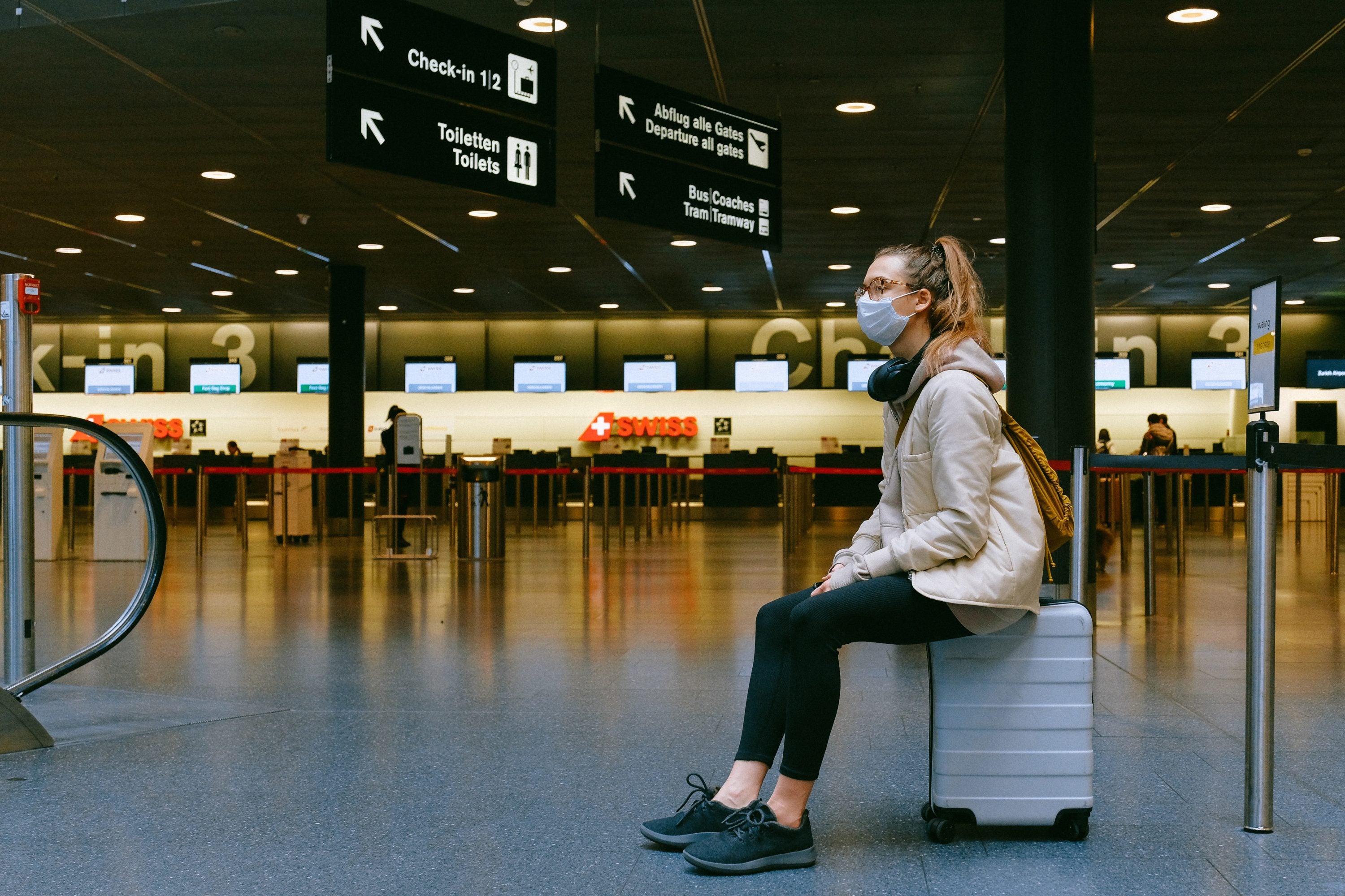 woman sitting on luggage 3943882
