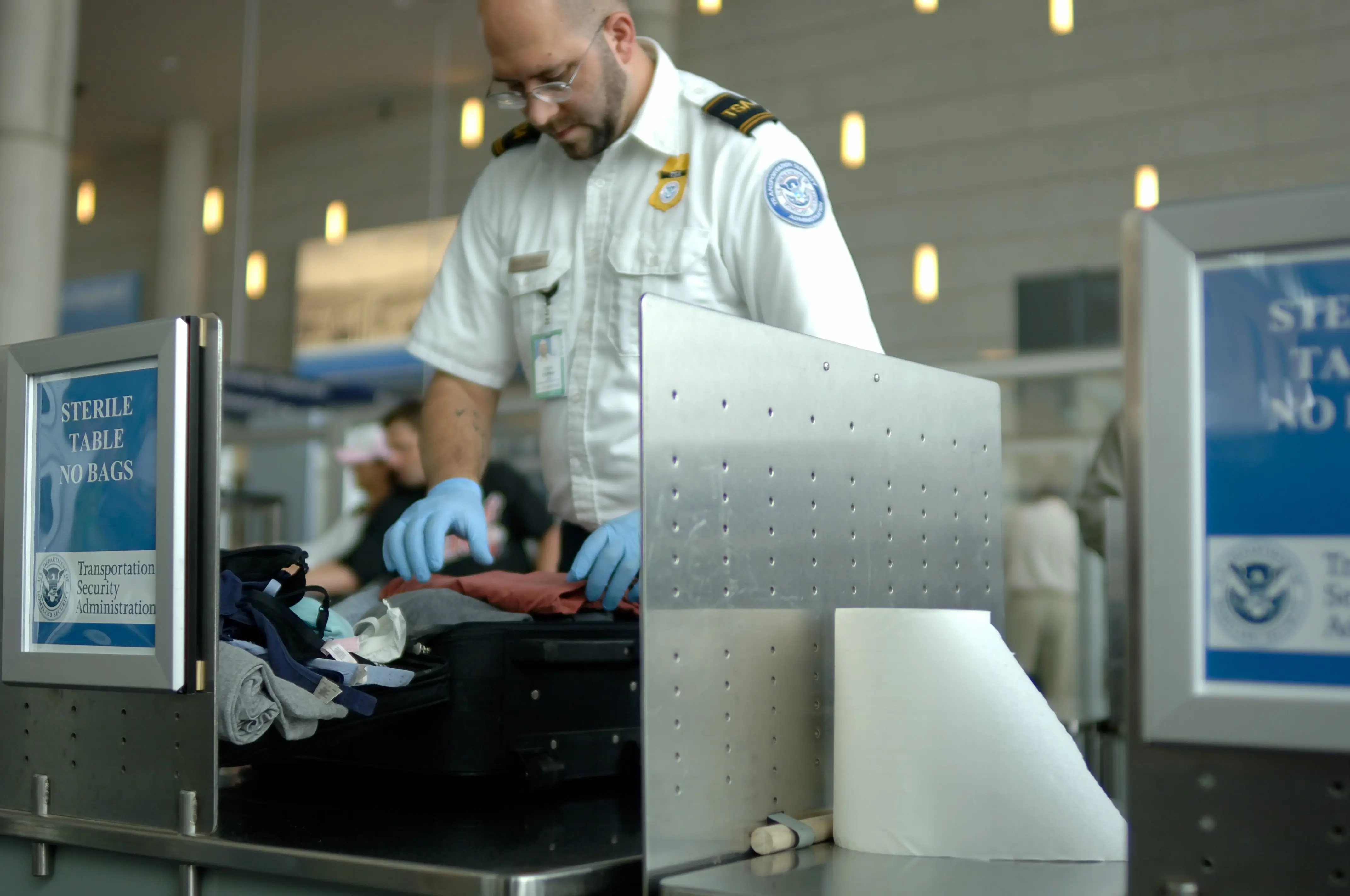 TSA officer searches bag