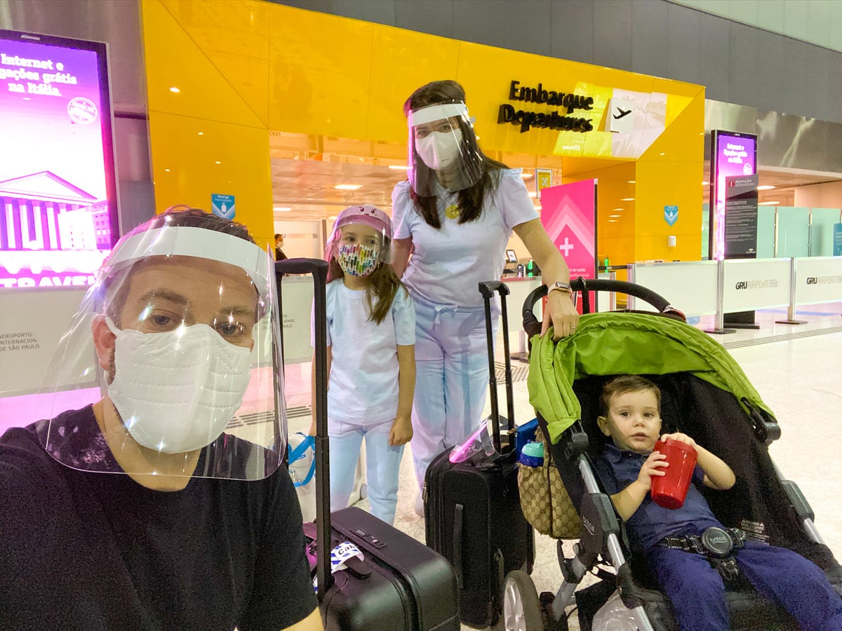 Family before airport security with face masks