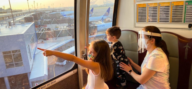 Family riding the terminal train at EWR during sunrise New Jersey