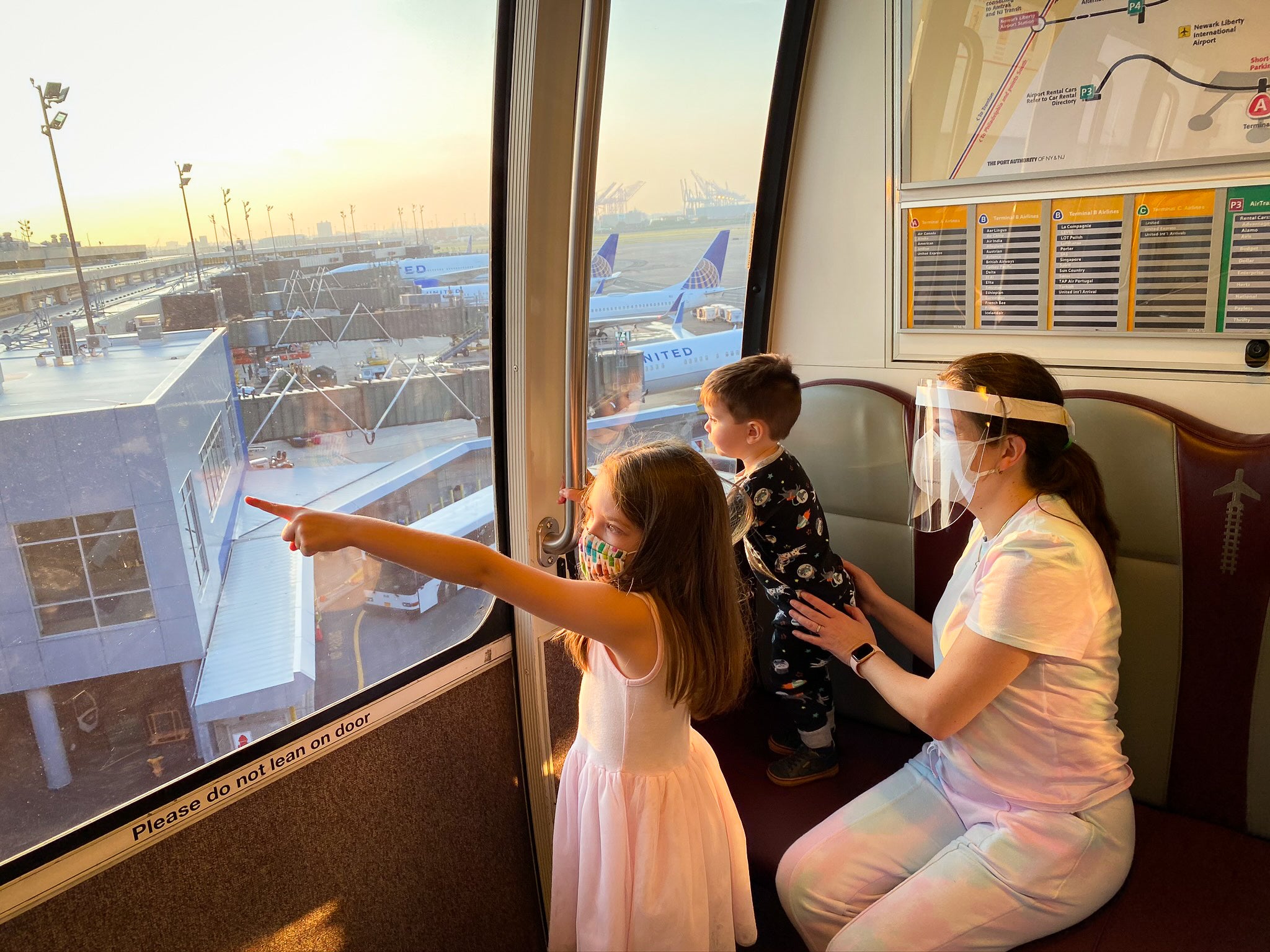 Family riding the terminal train at EWR during sunrise New Jersey