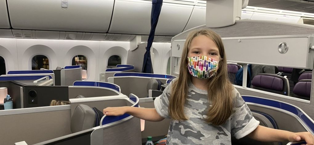 Girl wearing mask in United Polaris Business Class