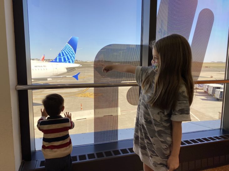 Kids looking at Boston Logan Airport BOS runway Kids looking at Boston Logan Airport BOS runway