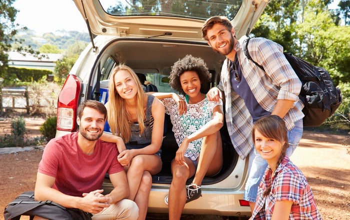 young adults outside of a van