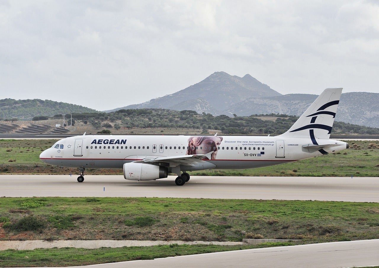 Aegean Airlines plane with mountain in background
