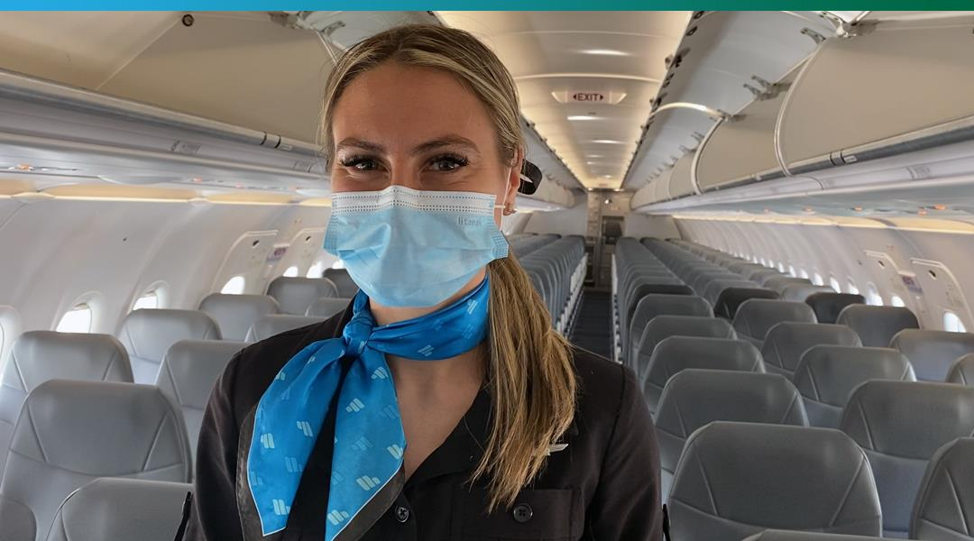 Frontier flight attendant wearing a mask