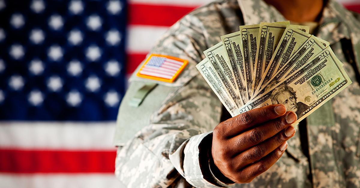 Military solider holding cash