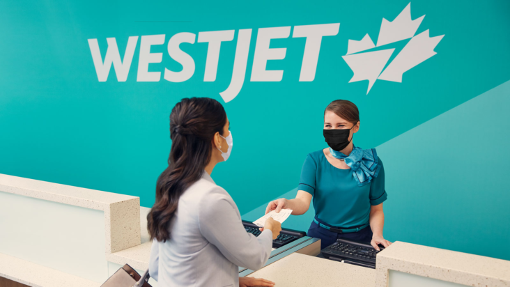 WestJet Agent and Passenger wearing masks WestJet Agent and Passenger wearing masks