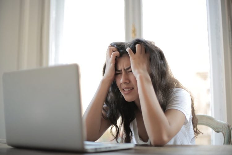 Angry woman frustrated at her laptop