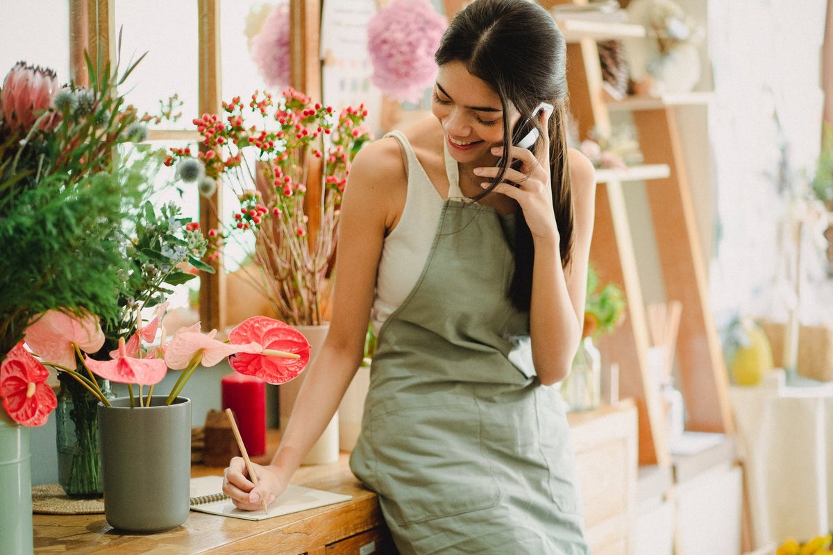 Business woman taking order on cell phone