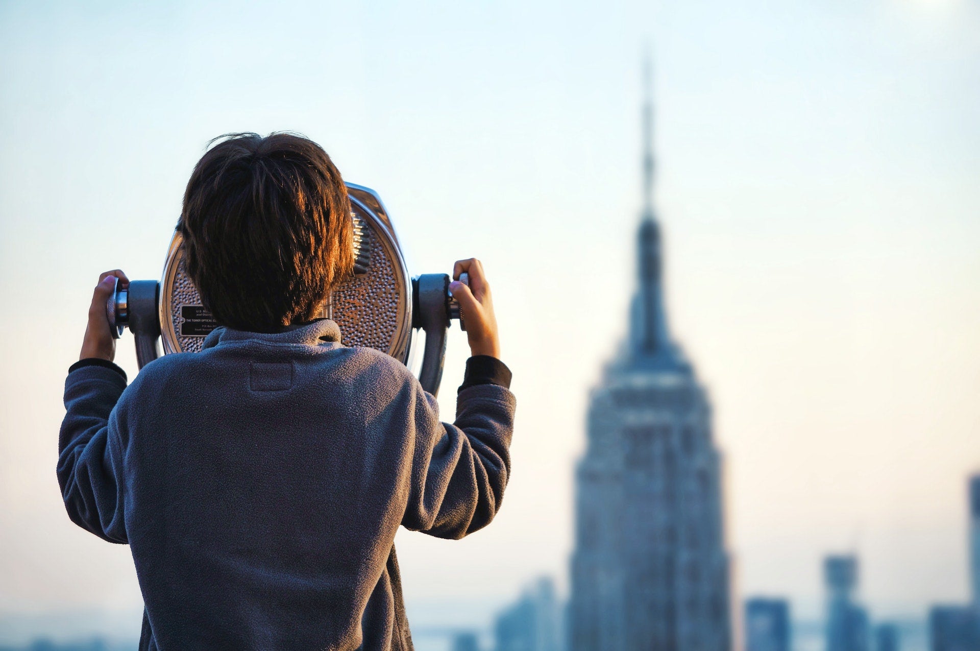 Boy looking at Empire State Building in New York City