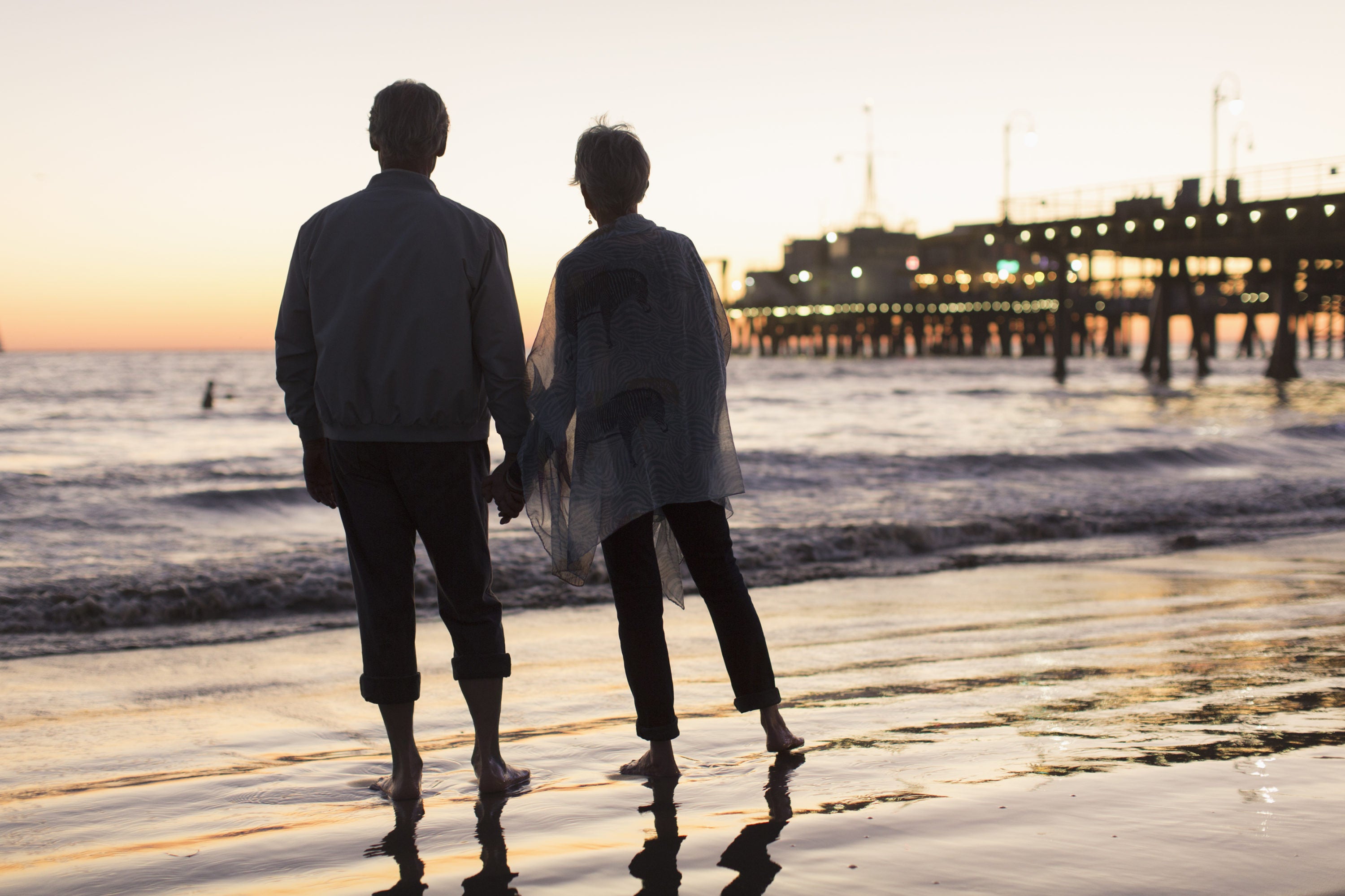 Senior couple on beach at sunset