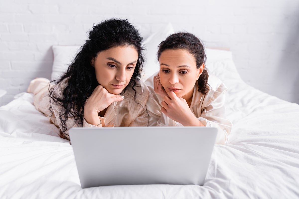 2 women on laptop in thought