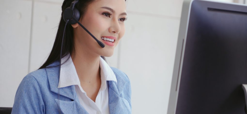 Call center woman with headset smiling