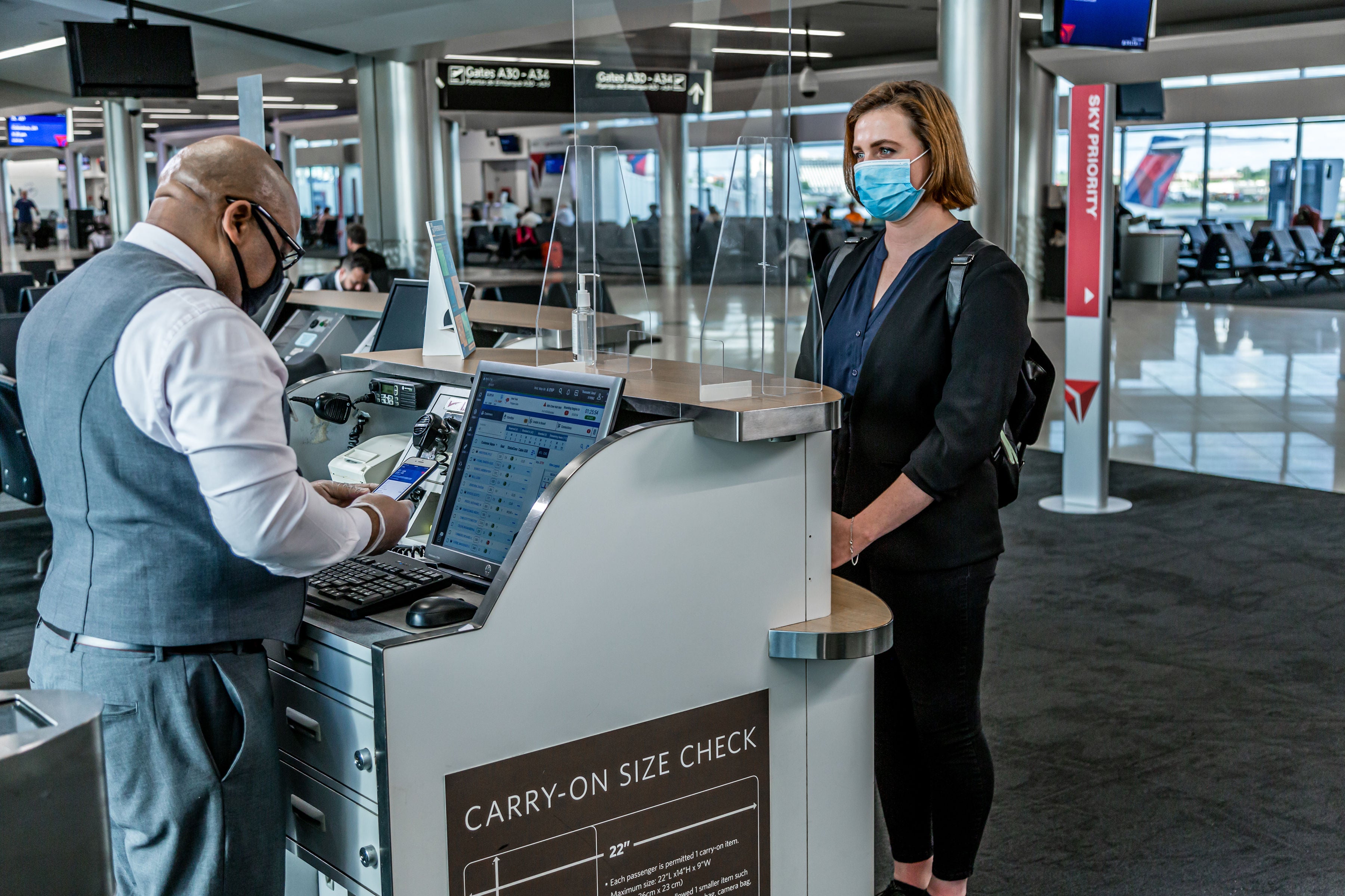 Delta employee and customer in masks at gate