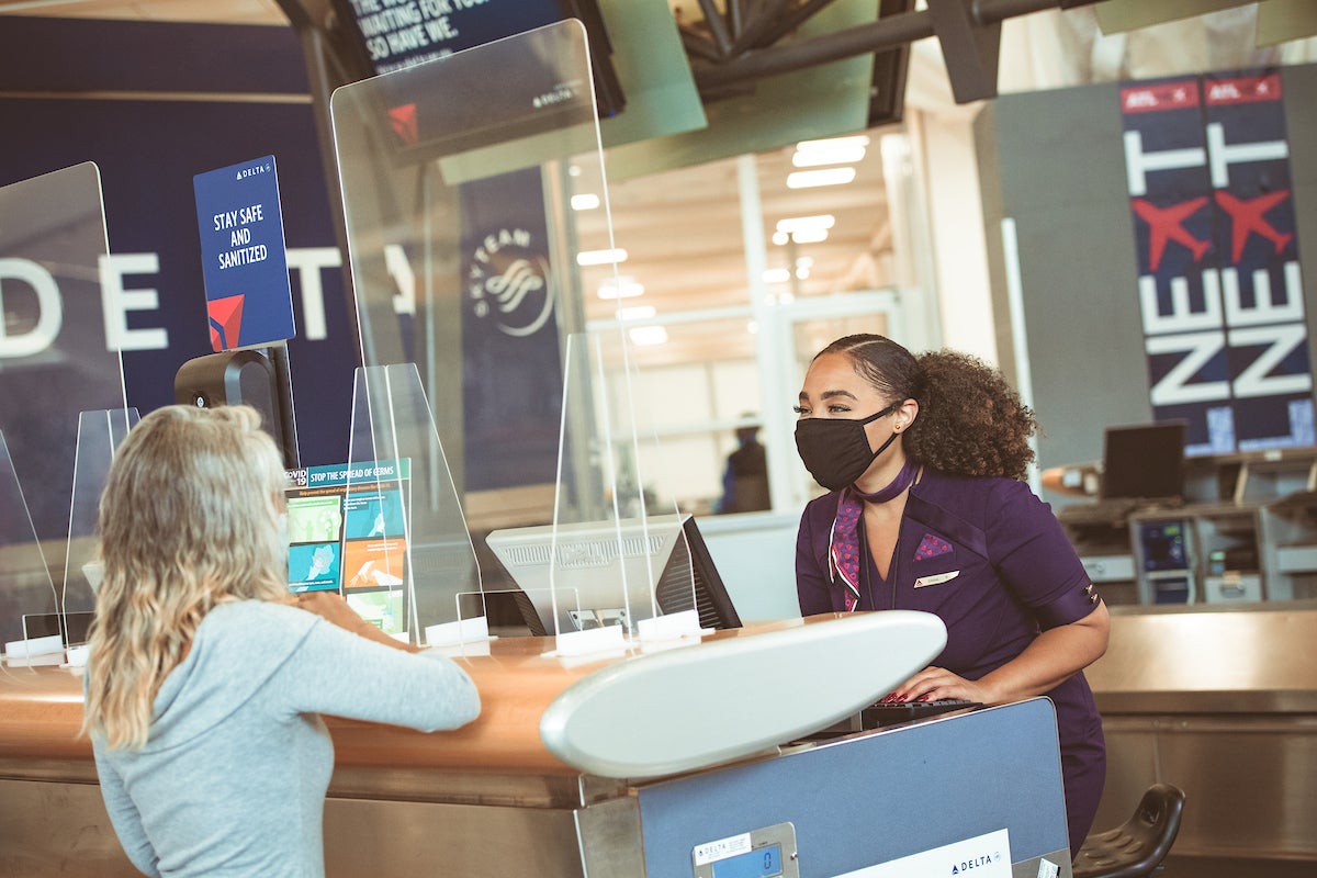 Delta employee and passenger at gate in masks