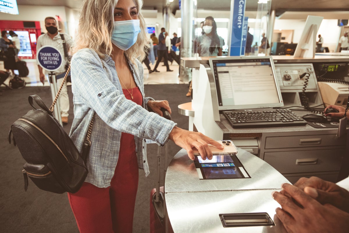 Delta passenger scanning boarding pass at gate