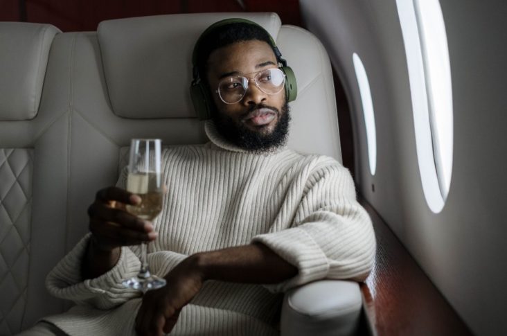 Man with headphones on plane Man with headphones on plane