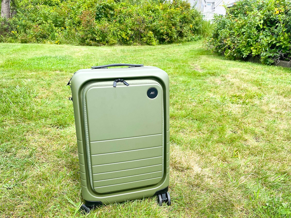 Olive Green Monos Luggage Carry On Pro on grass