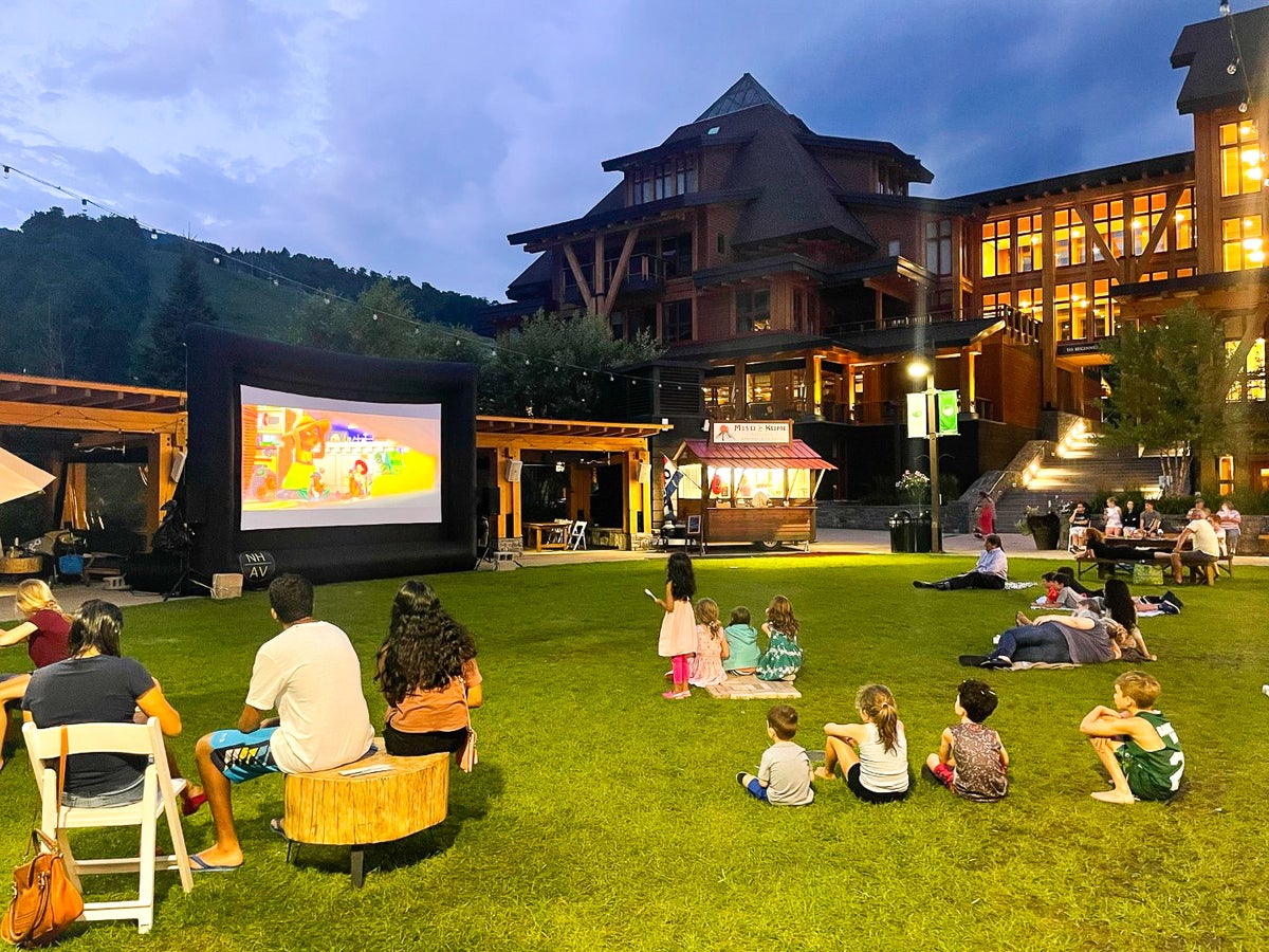 Evening movie screen on the Village Green at The Lodge at Spruce Peak Destination by Hyatt Stowe Vermont