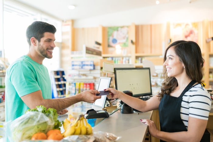 Man paying for groceries at supermarket Man paying for groceries at supermarket