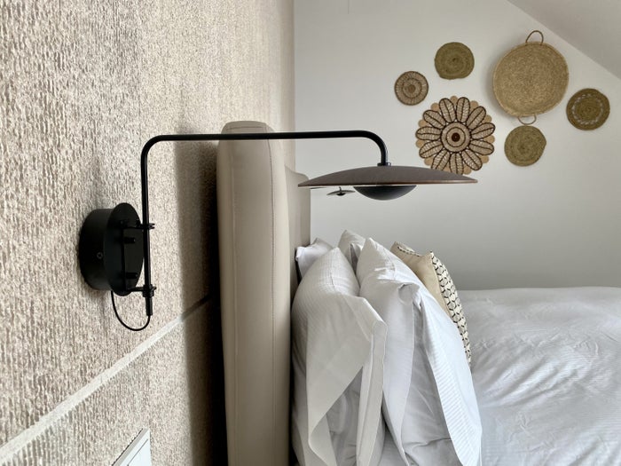 The Atocha Hotel Madrid Tapestry Collection by Hilton El Atochal Penthouse side view of bed