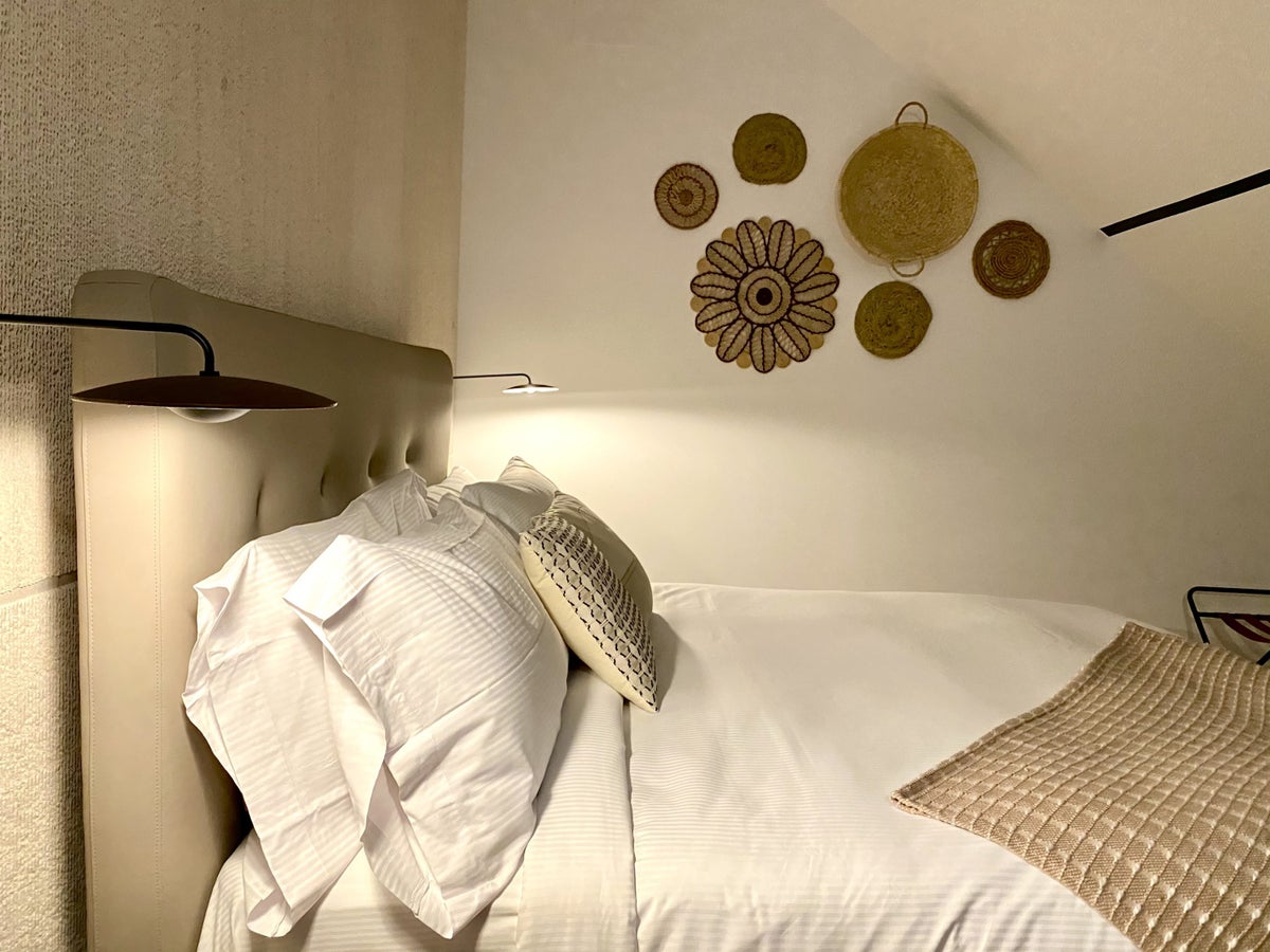 The Atocha Hotel Madrid Tapestry Collection by Hilton a close up of the bed in the El Atochal Penthouse Suite at