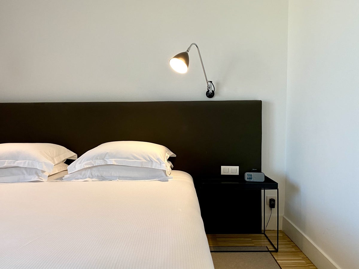 Alexandra Hotel Barcelona Curio Collection by Hilton bed and bedside table in King Junior Suite with Terrace