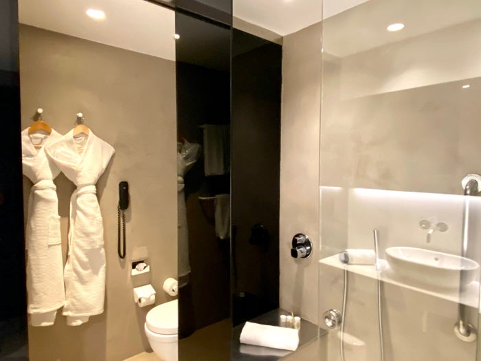 Alexandra Hotel Barcelona Curio Collection by Hilton in shower seat and toilet room