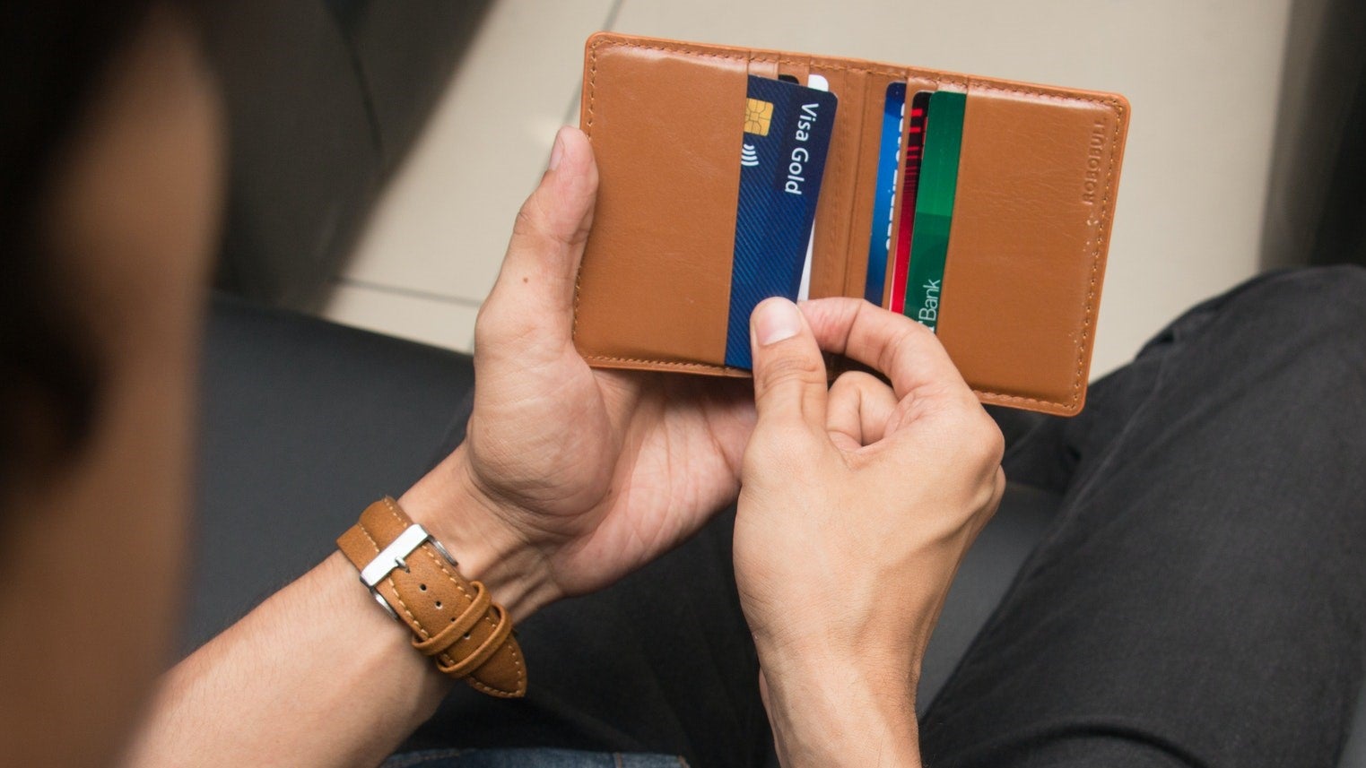 Man Pulling Cards From Wallet