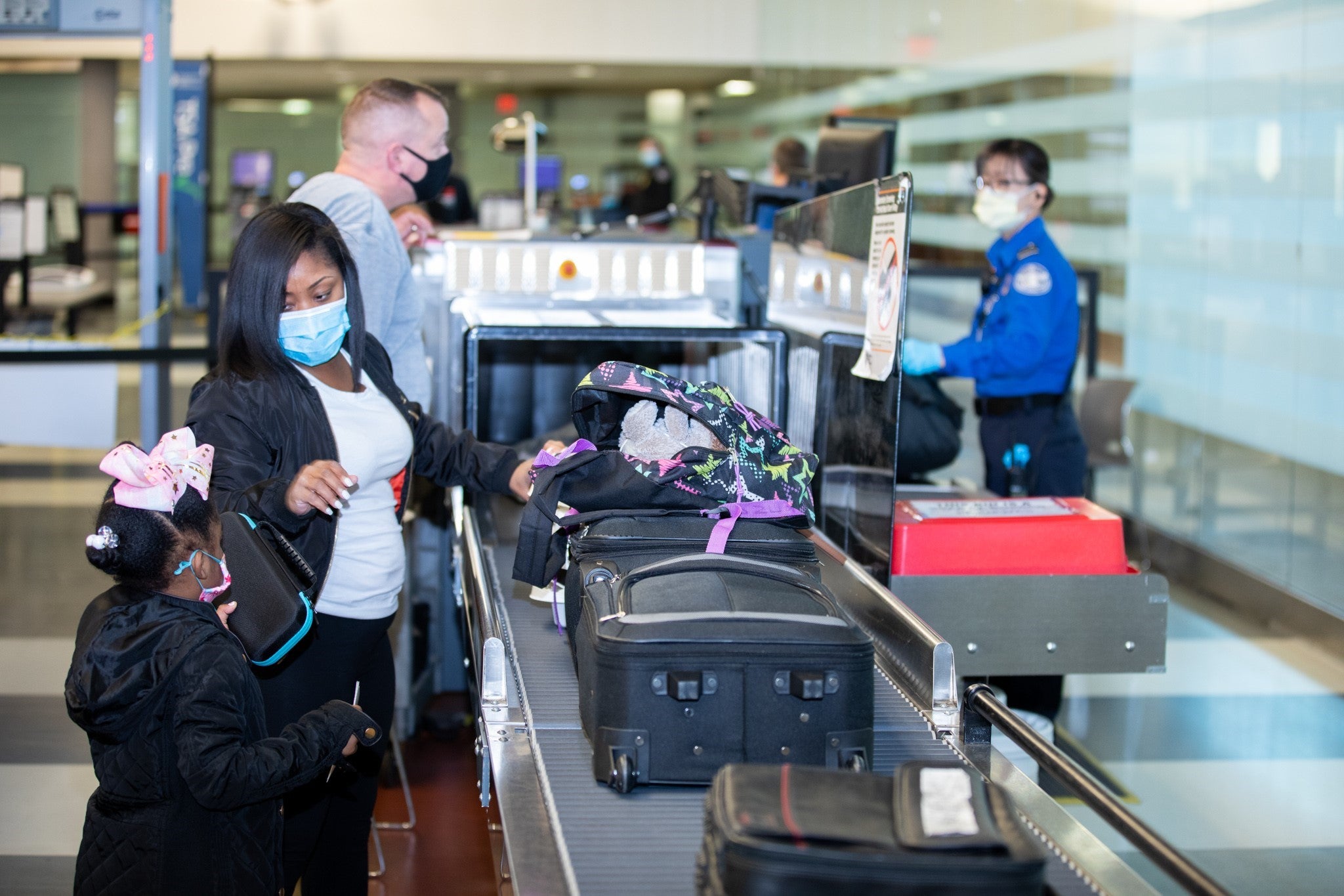 Travelers and TSA officers wearing masks
