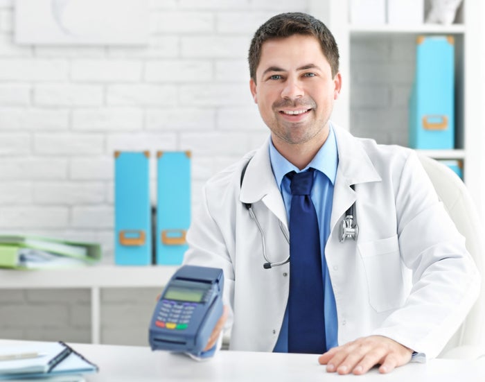 Doctor with credit card terminal Doctor with credit card terminal