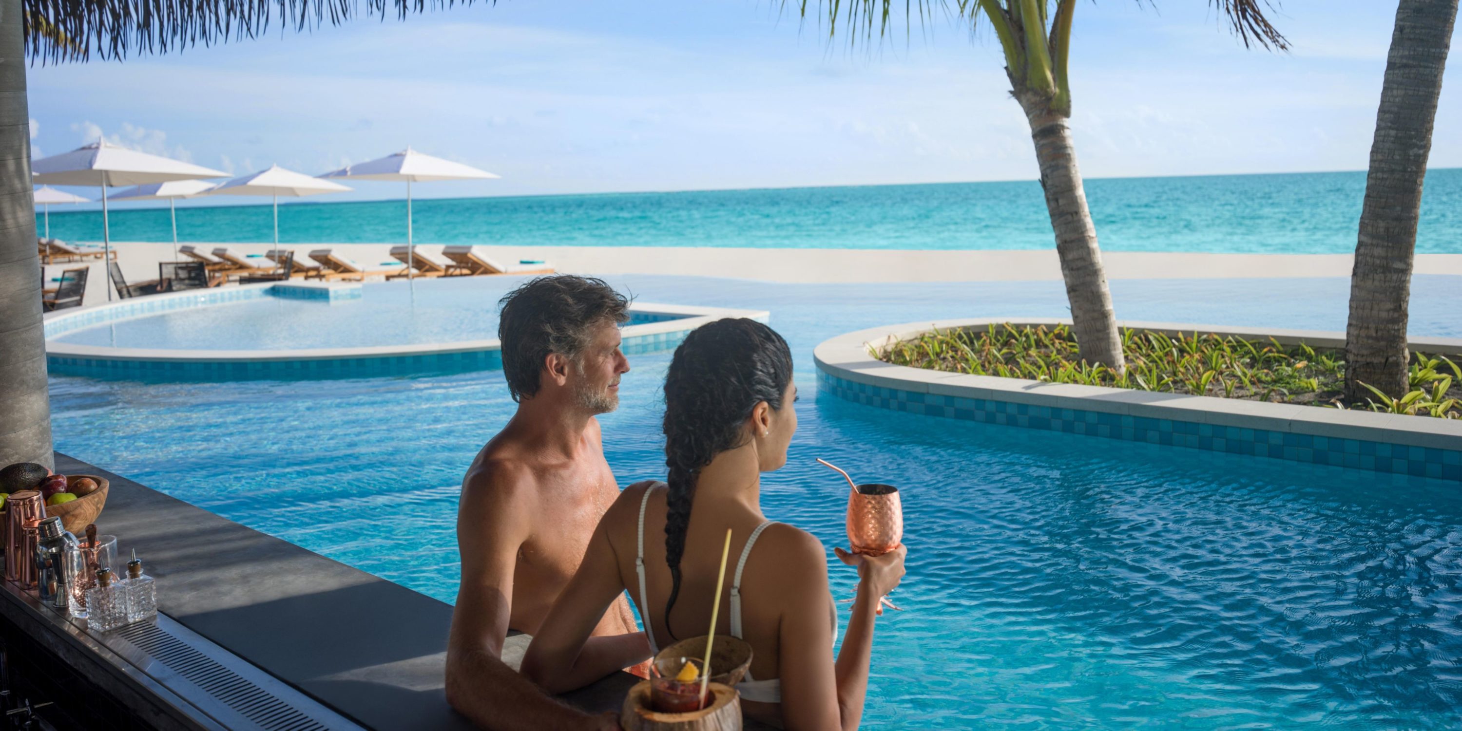 InterContinental Maldives Maamunagau Resort couple at pool