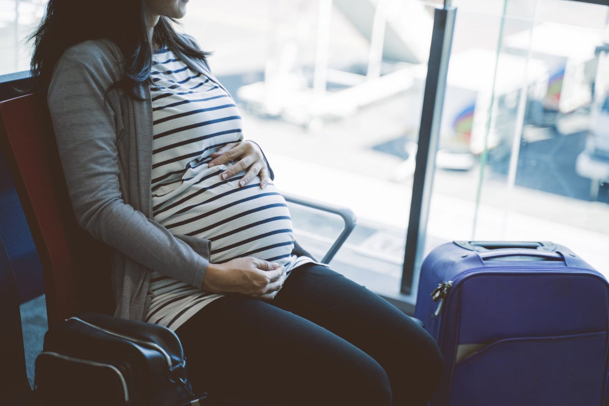 Pregnant woman sitting airport