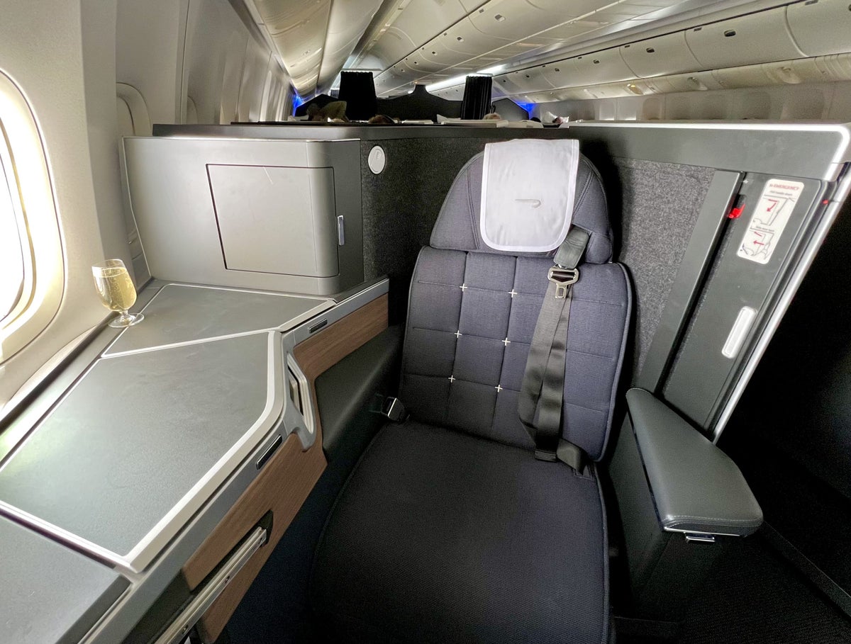 British Airways Boeing 777 300 Club Suite seat 9K with glass of Champagne