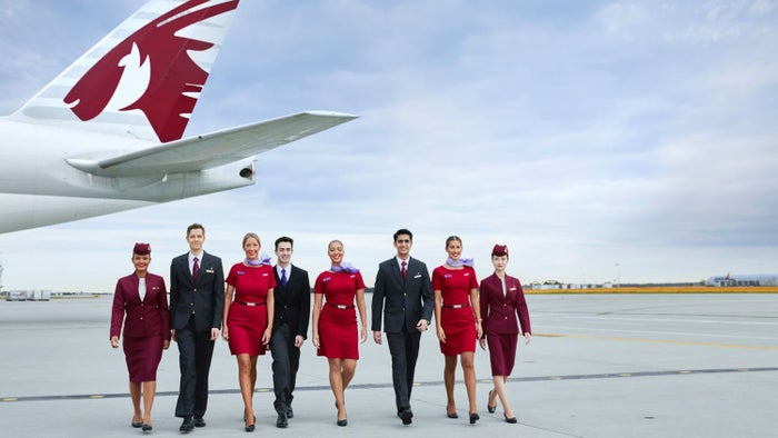 Qatar and Virgin Flight Attendants Walking