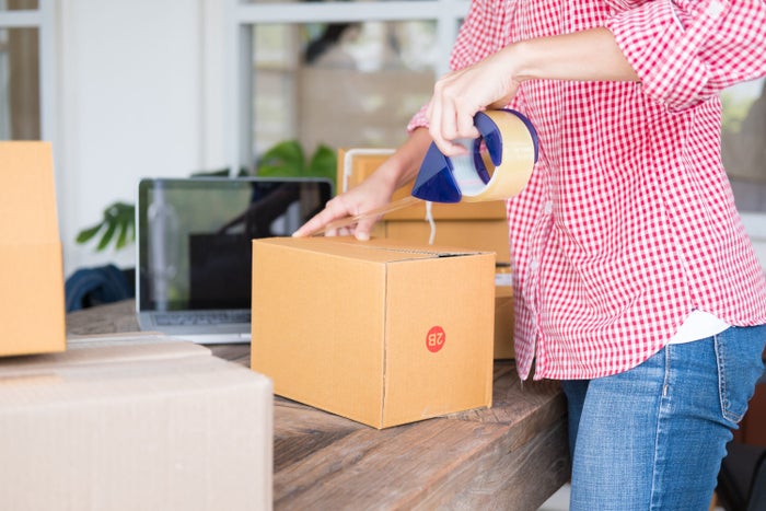 woman packing a box woman packing a box