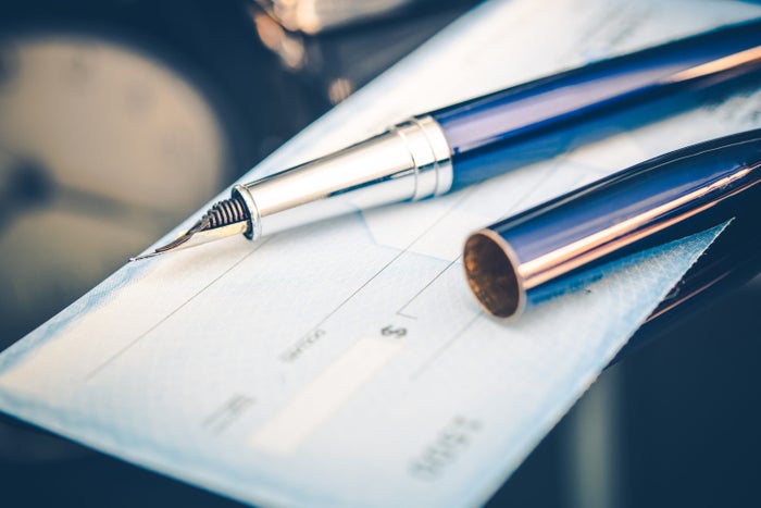 Issuing Payment by Check by Using Elegant Fountain Pen Issuing Payment by Check by Using Elegant Fountain Pen