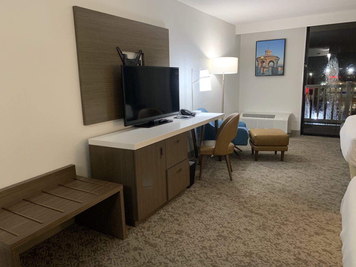 Desk, TV, dresser, seating area, and luggage rack at the DoubleTree by Hilton Corpus Christi Beachfront