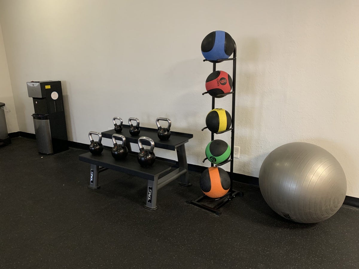 Water station, kettlebells, medicine balls, and a balance ball in the fitness center at the DoubleTree by Hilton Corpus Christi Beachfront
