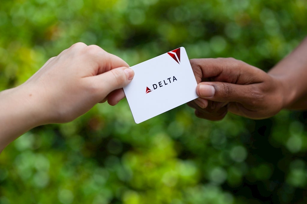 Delta gift card exchanging hands