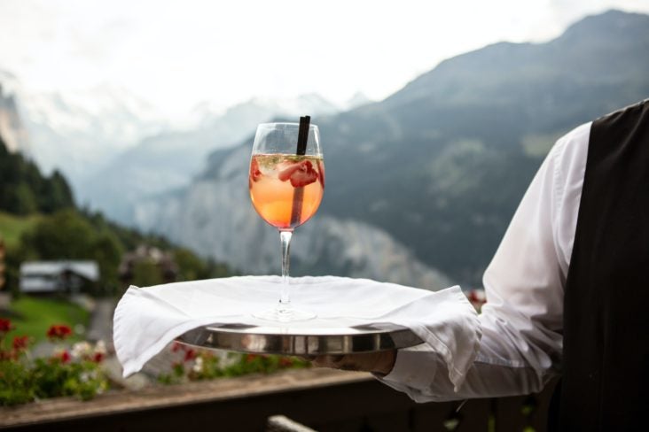 Server holding tray with cocktail