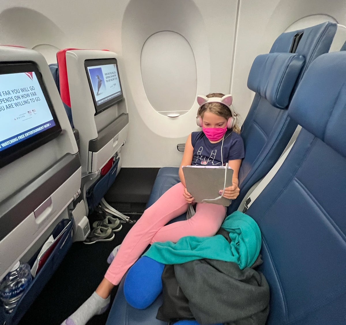 Girl watching iPad on Delta A350-900 economy