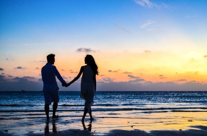 Couple walking on beach Couple walking on beach