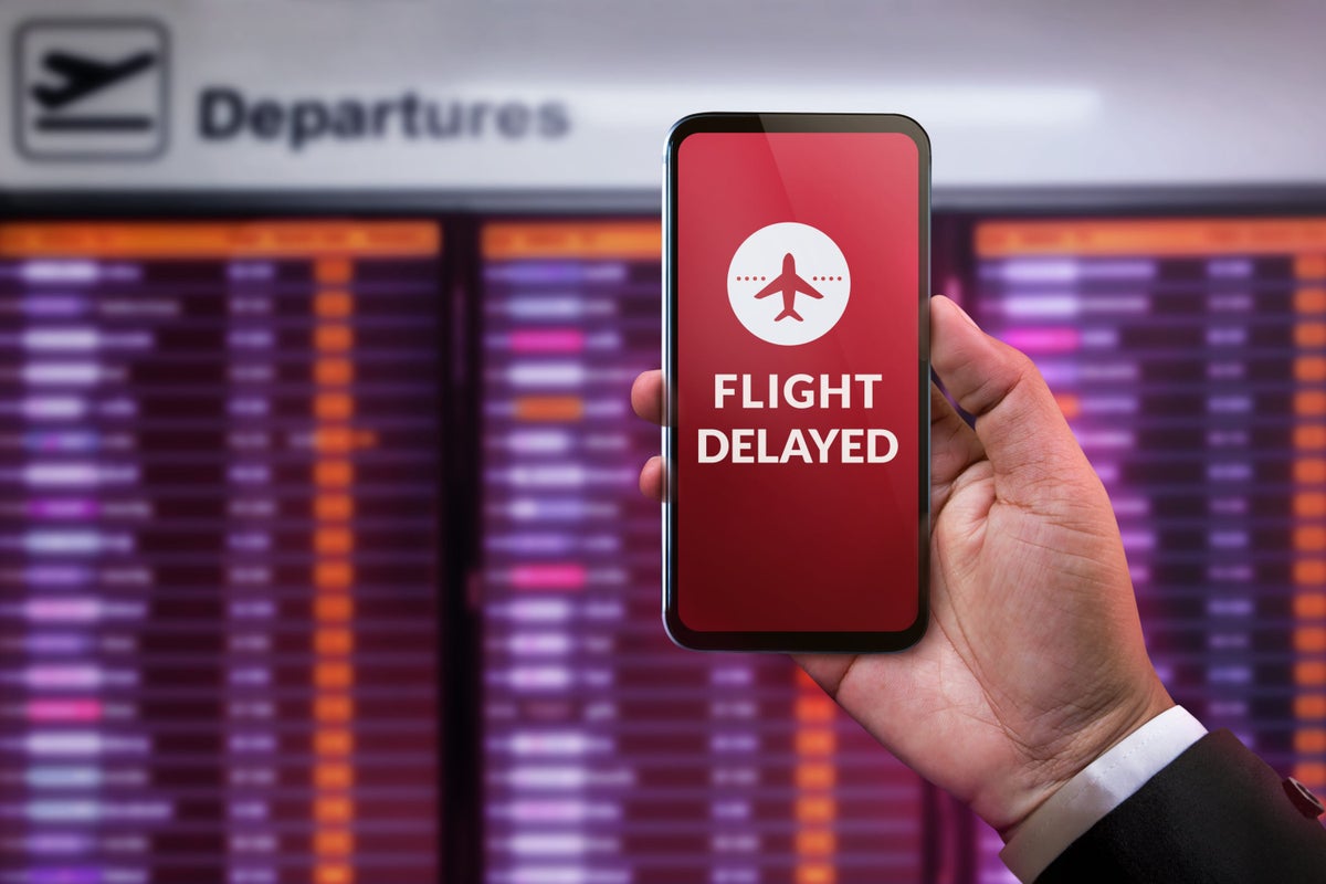 Phone displaying flight delayed at airport