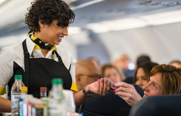 Spirit passenger buying item from flight attendant Spirit passenger buying item from flight attendant