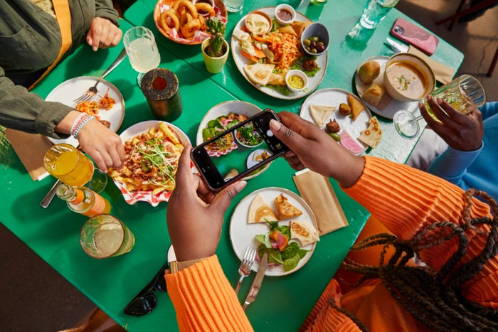 Women dining at restaurant taking picture