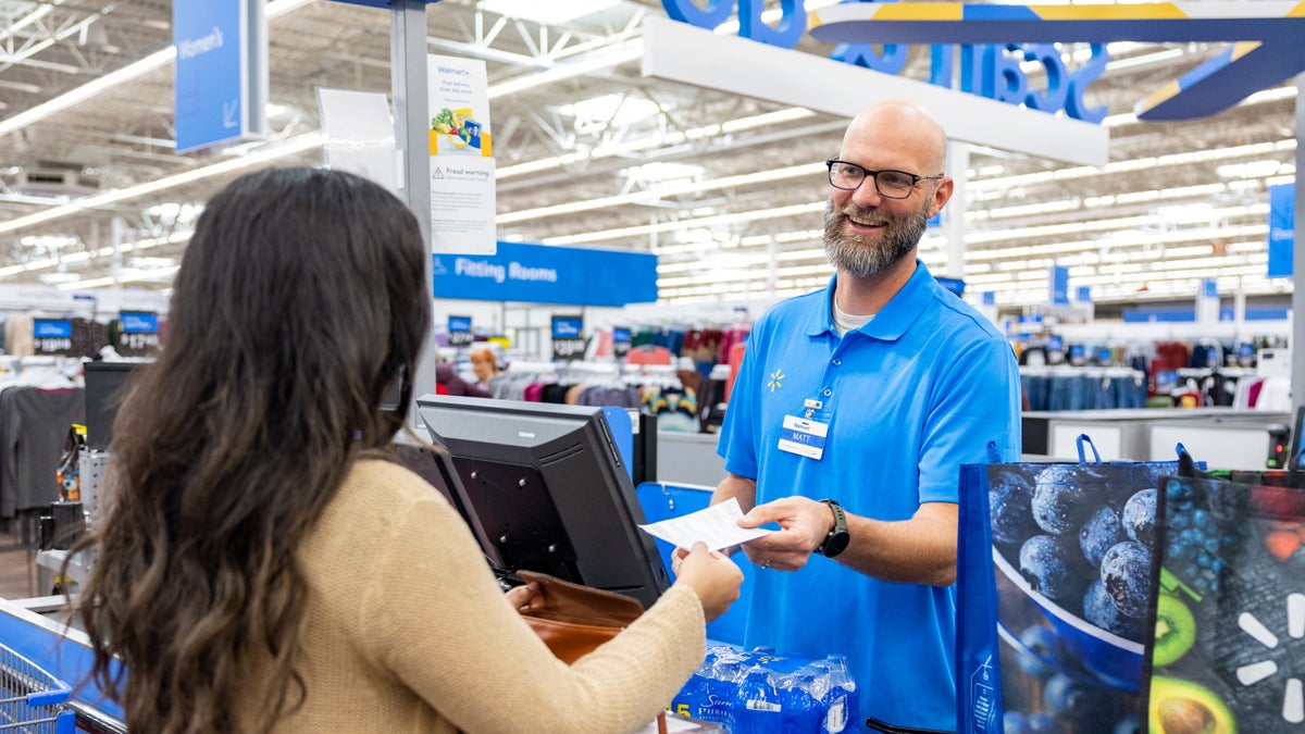 Walmart associate talking with customer