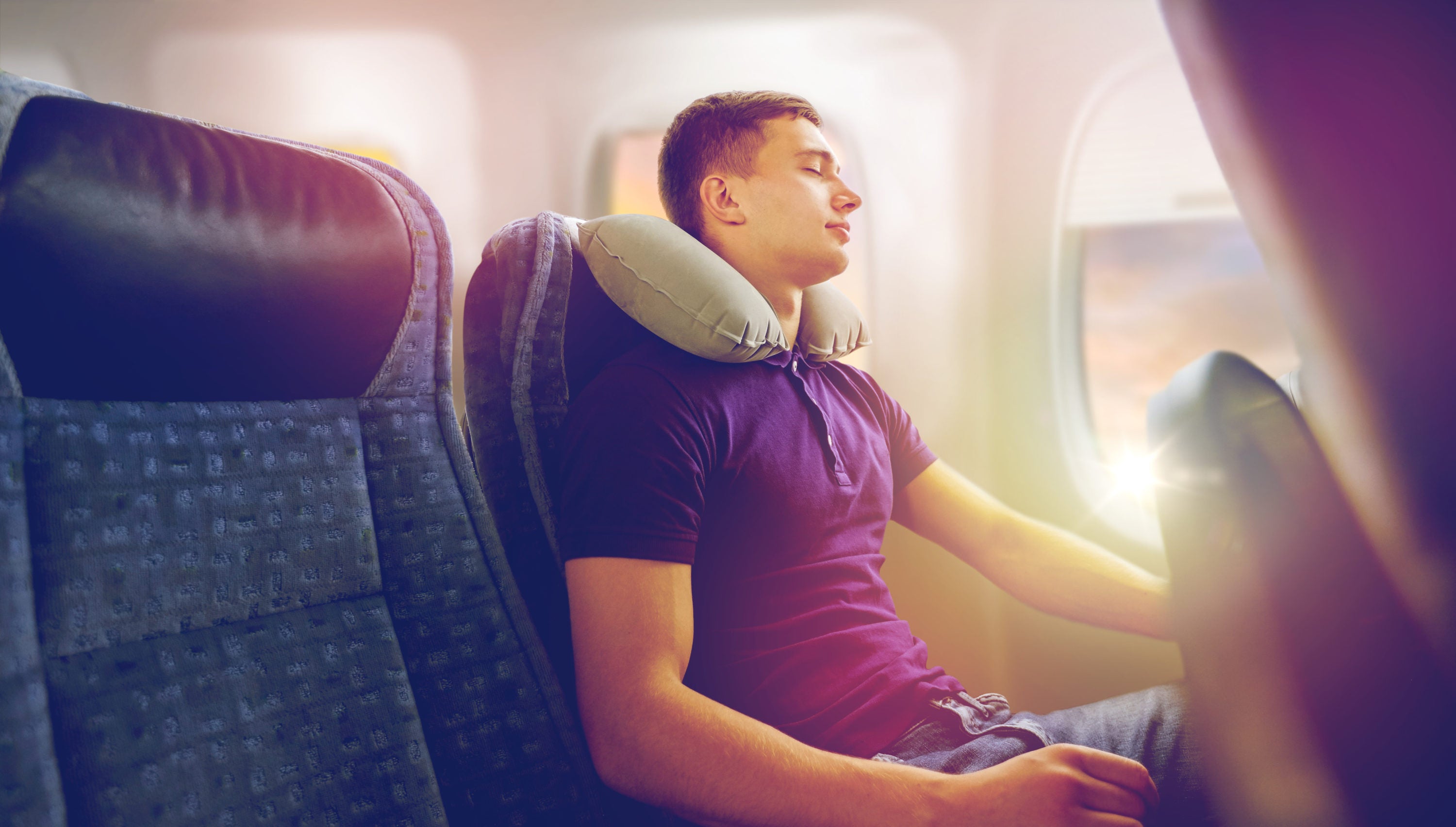 Man flying with neck pillow